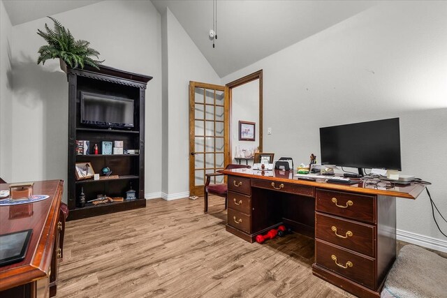 office featuring high vaulted ceiling and light hardwood / wood-style floors