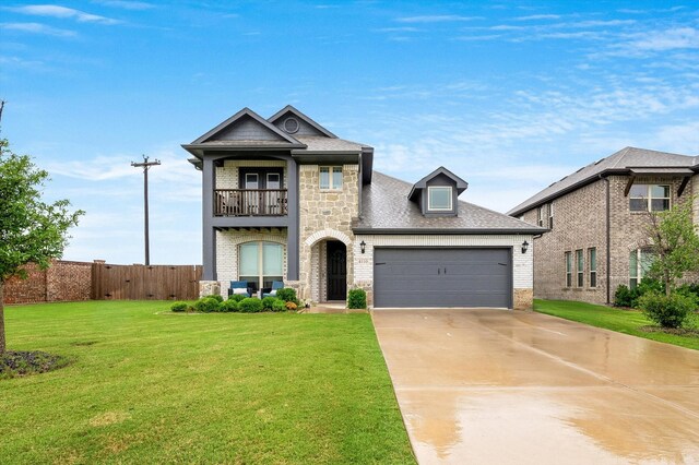 view of front of house featuring a balcony, a front yard, and a garage