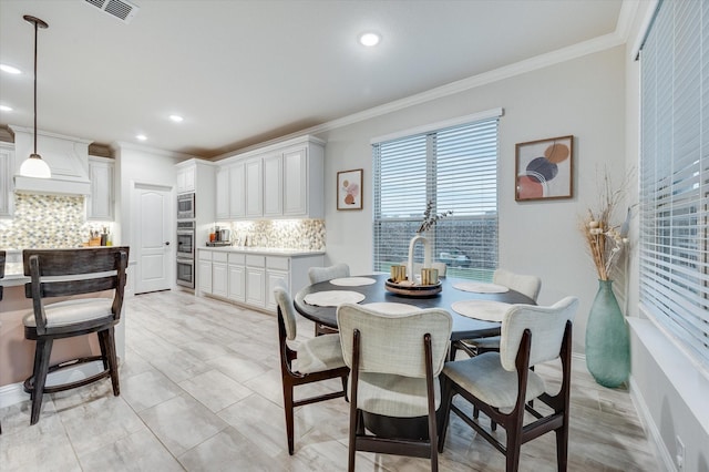 dining room featuring crown molding