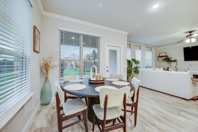 dining room with light hardwood / wood-style flooring, ceiling fan, and crown molding