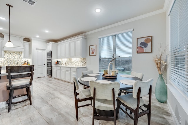 tiled dining area featuring ornamental molding