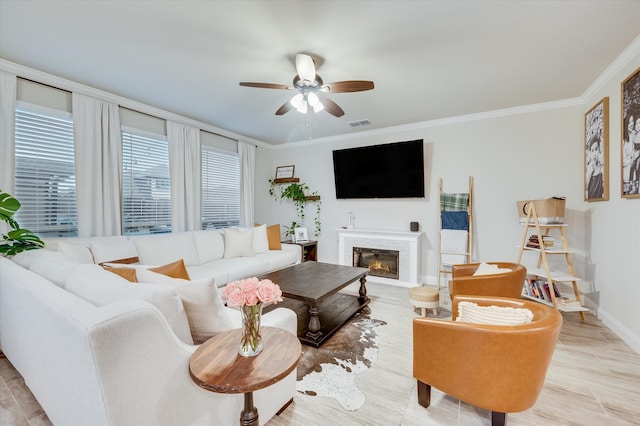 living room featuring ceiling fan and crown molding