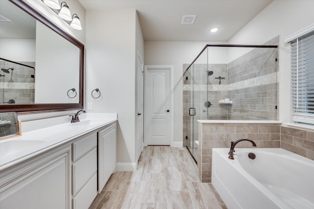 bathroom featuring vanity and plus walk in shower