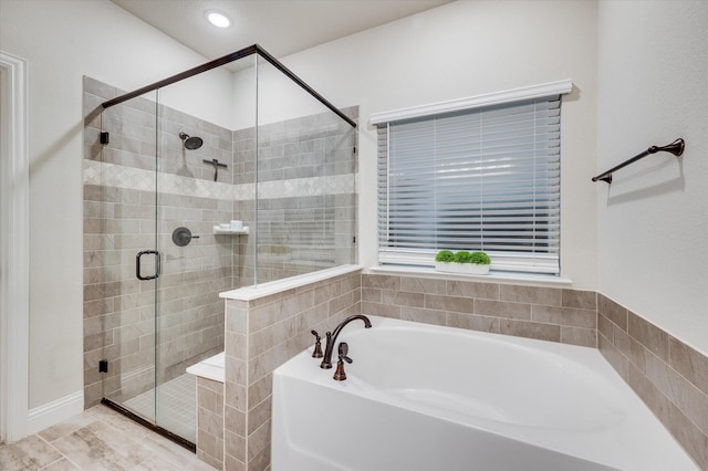 bathroom featuring independent shower and bath