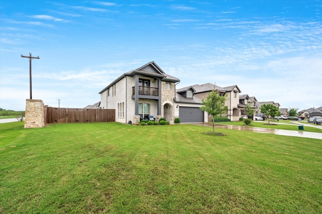 view of front of home with a balcony, a front yard, and a garage