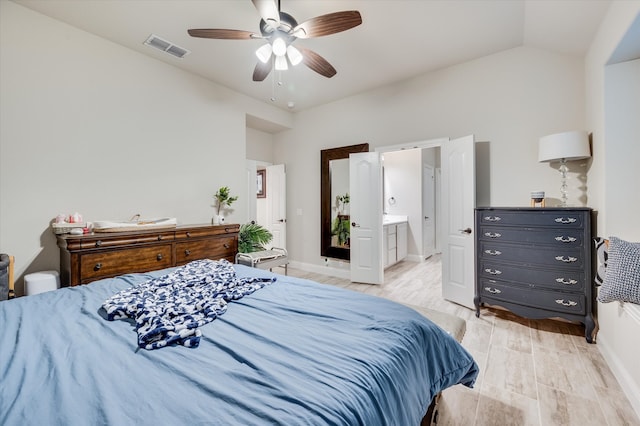 bedroom with ensuite bathroom, ceiling fan, light hardwood / wood-style flooring, and lofted ceiling