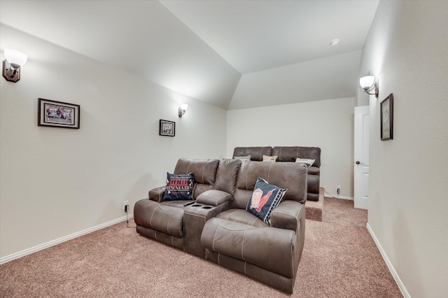 cinema room with vaulted ceiling and carpet flooring