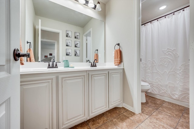 bathroom featuring vanity, tile patterned flooring, and toilet