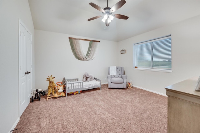 living area with carpet and ceiling fan