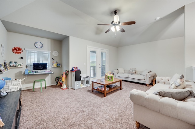 carpeted living room with french doors, a wealth of natural light, lofted ceiling, and ceiling fan