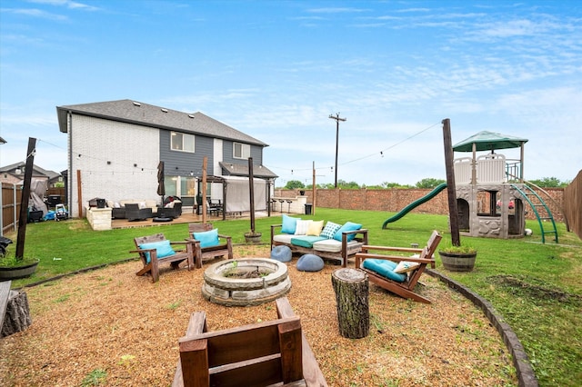 exterior space featuring a playground and an outdoor living space with a fire pit