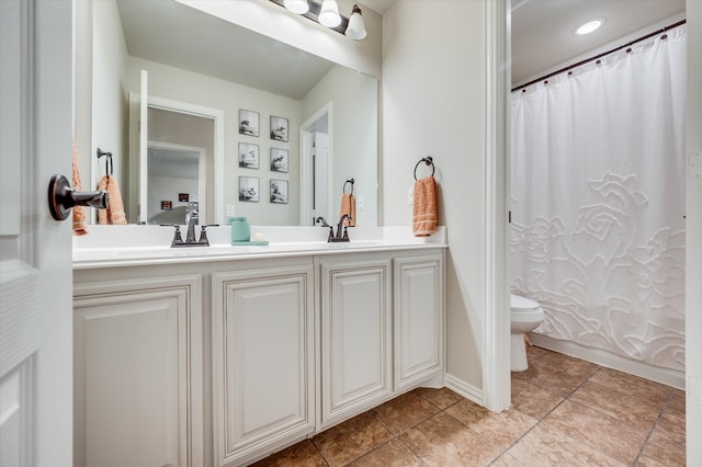 bathroom featuring vanity, tile patterned floors, and toilet