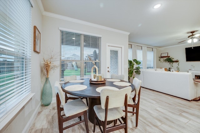 dining room featuring crown molding, light hardwood / wood-style flooring, and ceiling fan