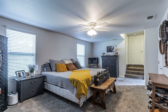 bedroom with a textured ceiling, ceiling fan, and carpet floors