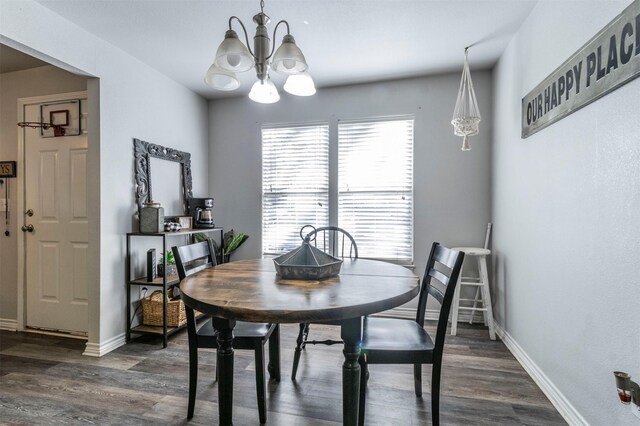 dining space featuring dark hardwood / wood-style flooring and a notable chandelier