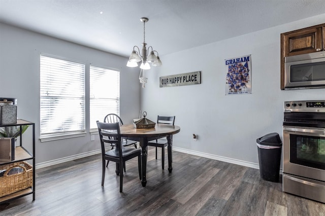 dining area with dark wood-type flooring and a chandelier