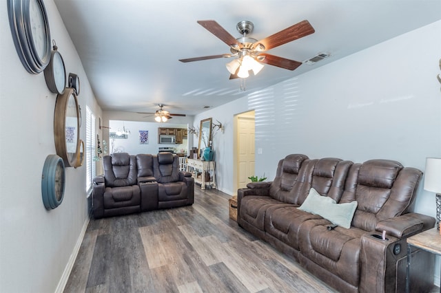 living room featuring wood-type flooring and ceiling fan