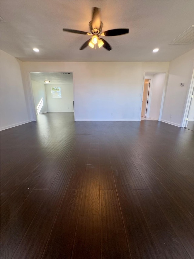 unfurnished room with ceiling fan and dark hardwood / wood-style flooring