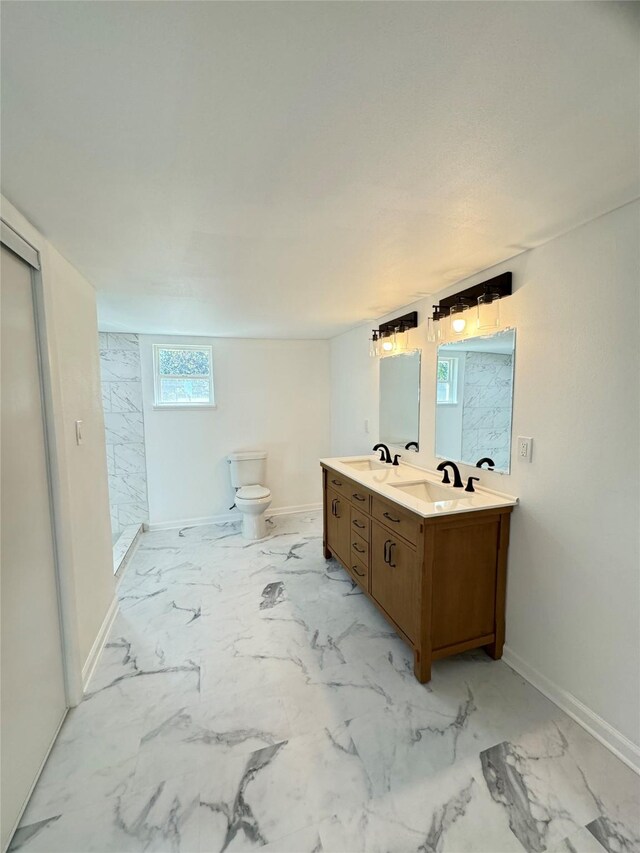 bathroom featuring walk in shower, vanity, toilet, and plenty of natural light