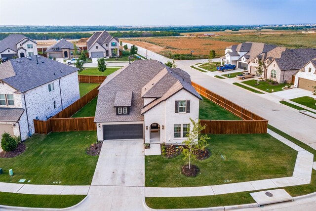 view of front of property featuring a garage and a front yard