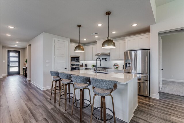 4104 Dartmoor Dr, Aubrey, TX 76227 - kitchen with stainless steel appliances, baseboards, recessed lighting, an island with sink, and white cabinets