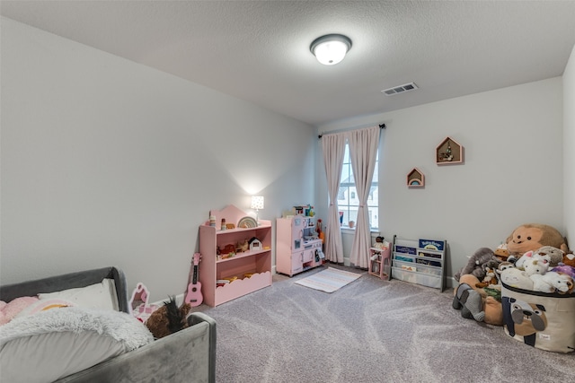 game room with a textured ceiling and carpet flooring