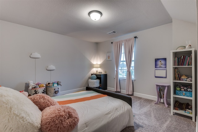 bedroom featuring carpet floors and a textured ceiling