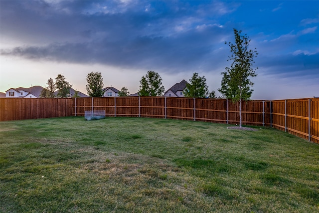 view of yard at dusk