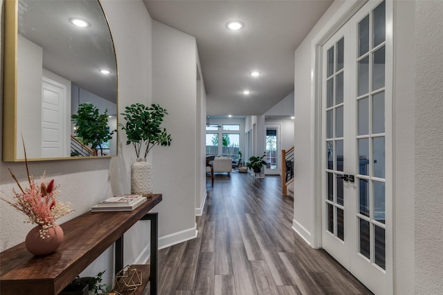 corridor with dark hardwood / wood-style floors and french doors