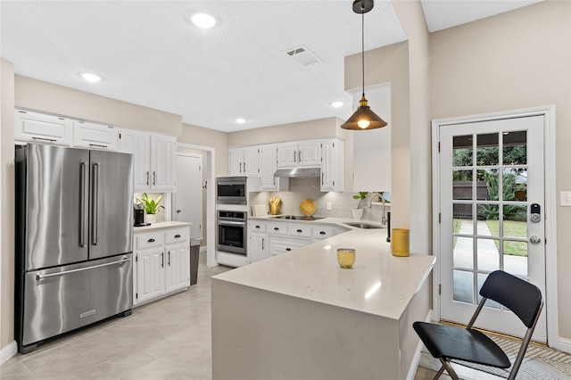 kitchen featuring stainless steel appliances, white cabinetry, and sink