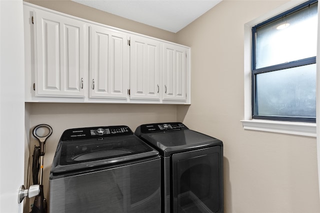 laundry area featuring cabinets and independent washer and dryer