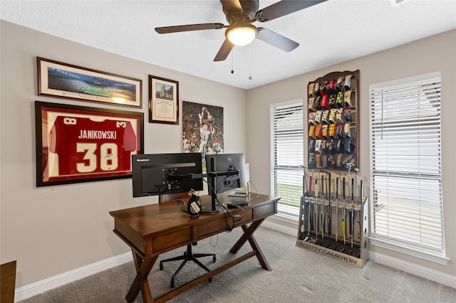 office area featuring ceiling fan, a textured ceiling, and carpet