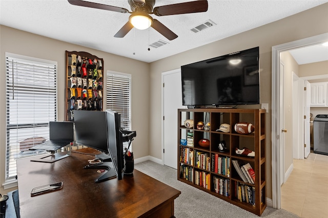 office area featuring light tile patterned flooring, a textured ceiling, and ceiling fan