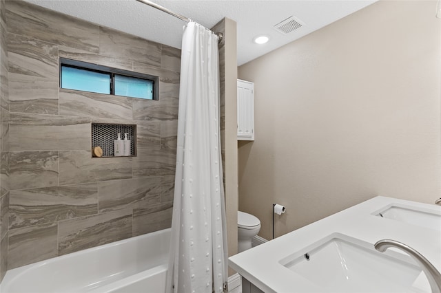 full bathroom with vanity, a textured ceiling, toilet, and shower / bath combination with curtain