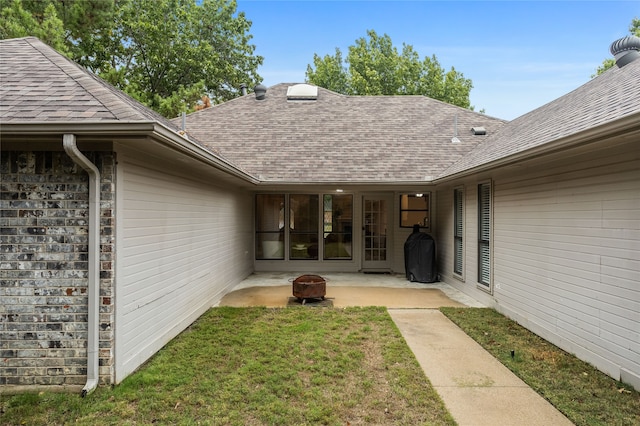 exterior space with a patio area and a lawn