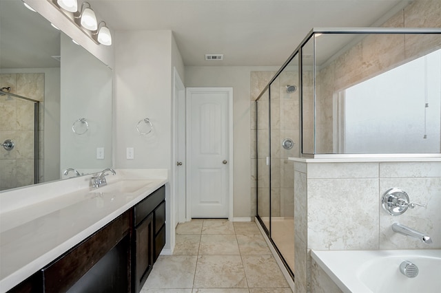 bathroom featuring tile patterned flooring, shower with separate bathtub, and vanity