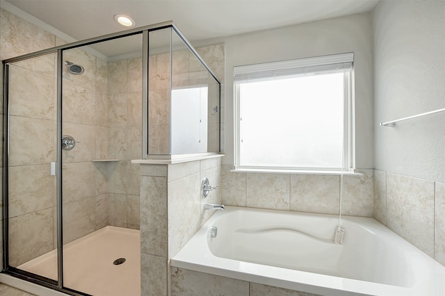 bathroom featuring separate shower and tub