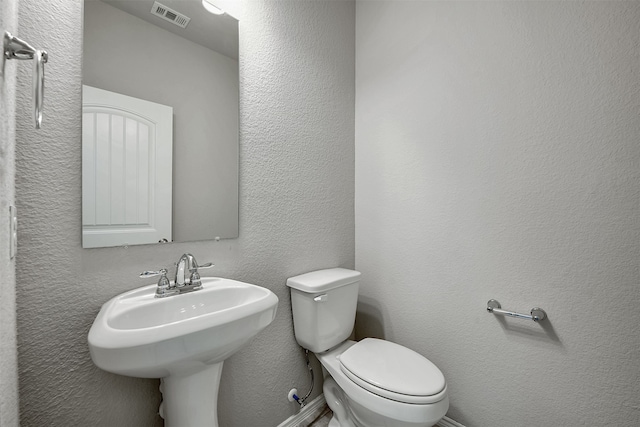 bathroom with toilet and sink