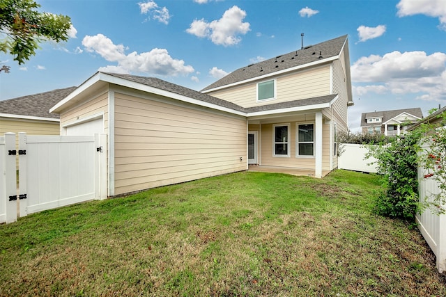 rear view of house with a lawn