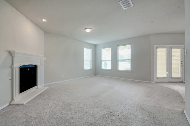 unfurnished living room with light colored carpet