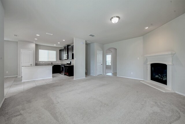 unfurnished living room with light colored carpet