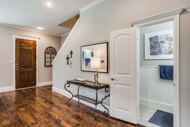 kitchen with crown molding, decorative light fixtures, a kitchen island, and light stone countertops