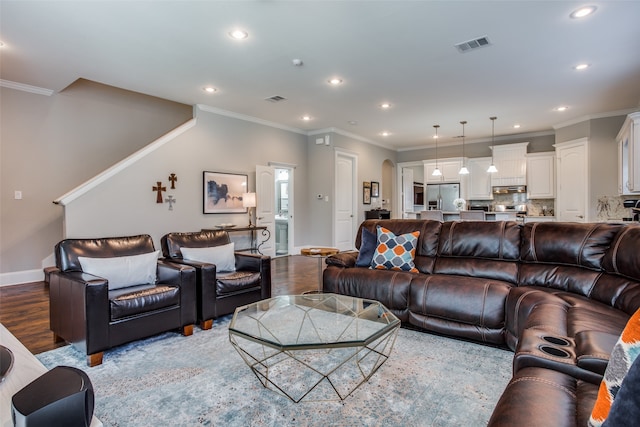 living room featuring ornamental molding, dark hardwood / wood-style flooring, and ceiling fan