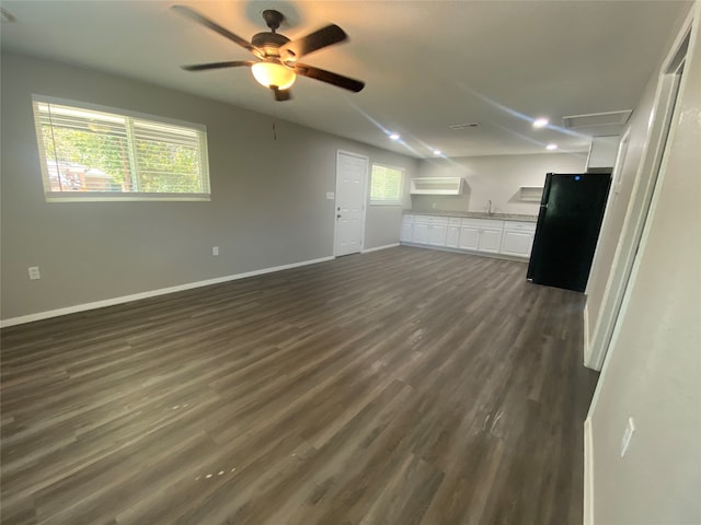 interior space with dark wood-type flooring and ceiling fan