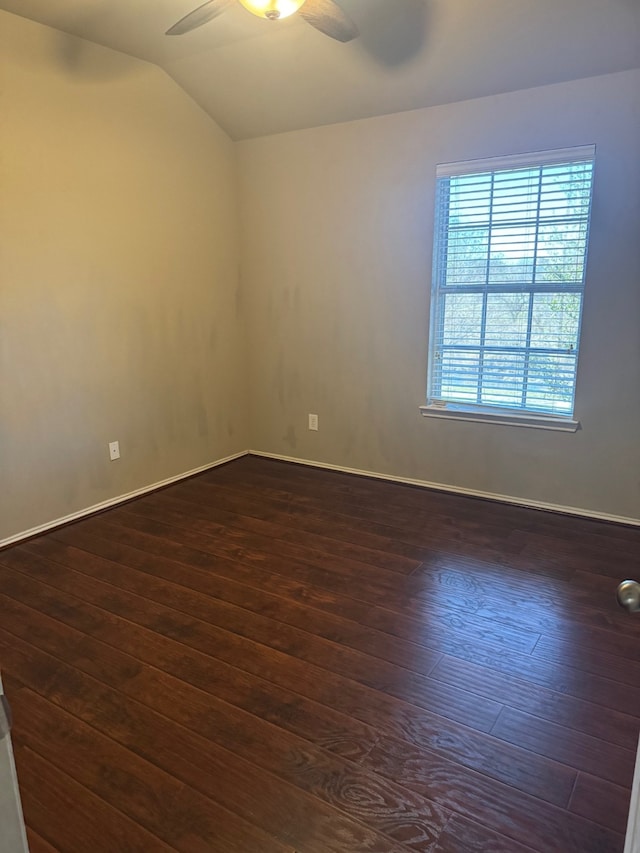 unfurnished room with vaulted ceiling, ceiling fan, and dark wood-type flooring