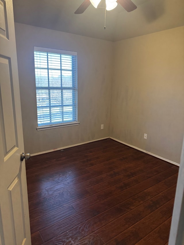 unfurnished room with dark hardwood / wood-style flooring and ceiling fan