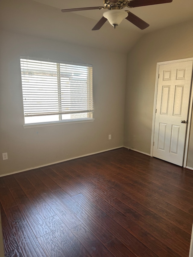 unfurnished room featuring ceiling fan, dark hardwood / wood-style flooring, and vaulted ceiling