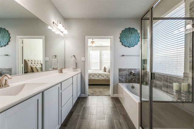 bathroom with shower with separate bathtub, vanity, and hardwood / wood-style flooring