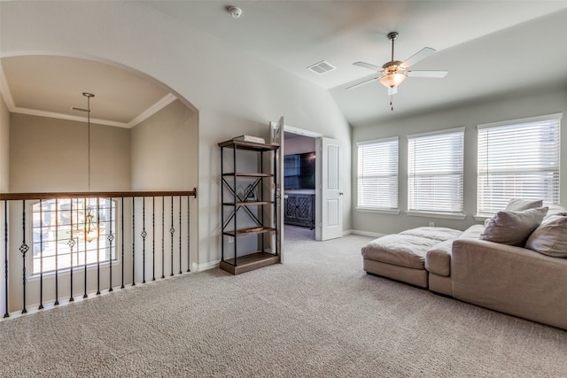 carpeted living room featuring a wealth of natural light, ceiling fan, lofted ceiling, and ornamental molding