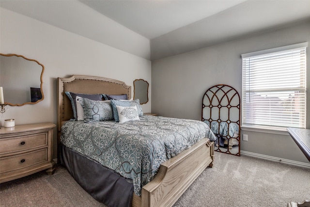 bedroom with carpet floors and vaulted ceiling